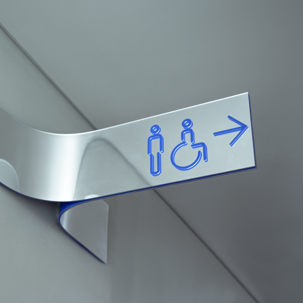 Wayfinding signage for men's and disabled bathooms, in blue, on shiny stainless sign
