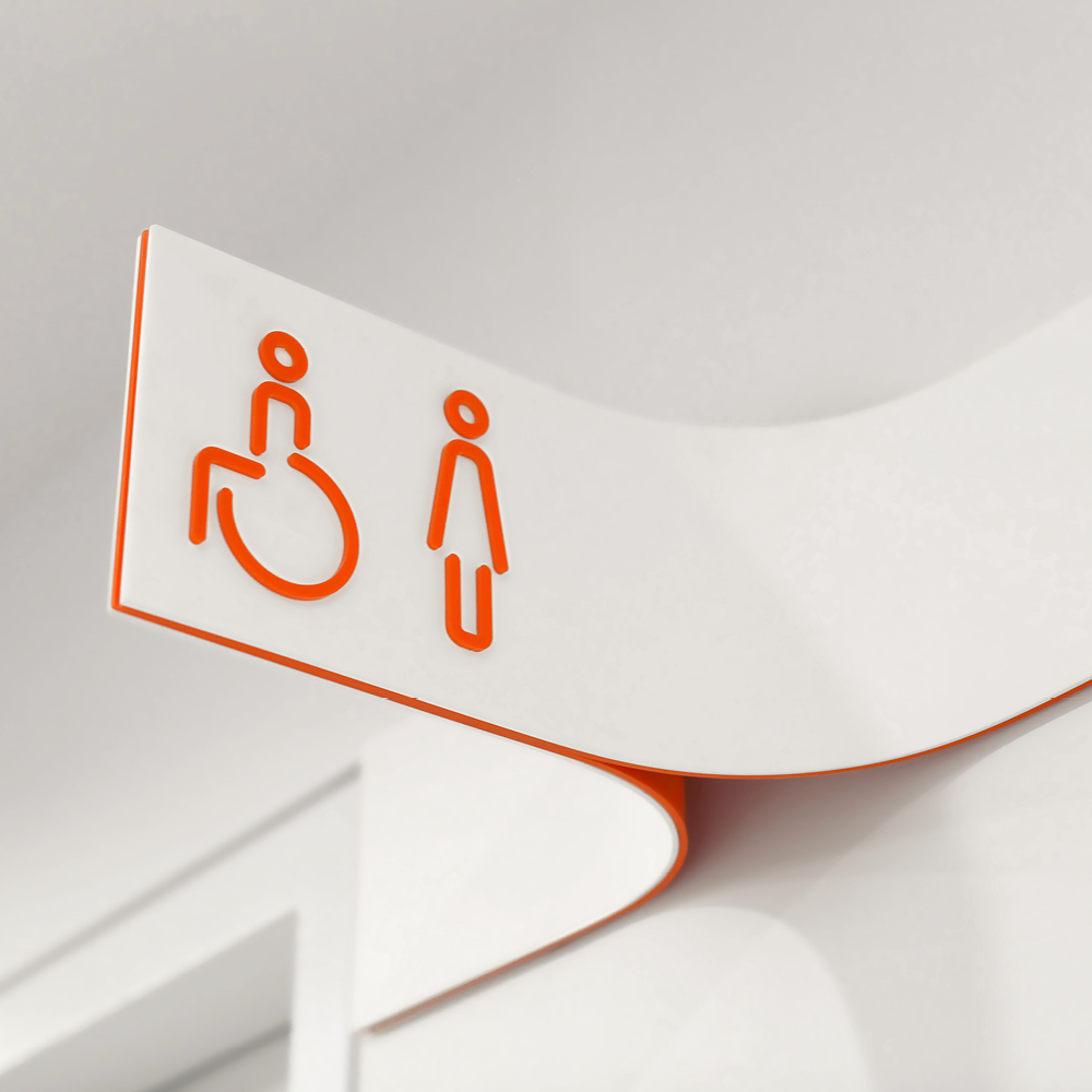 Accessible and female toilet signage attached to wall sign