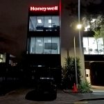 New signage on the Honeywell building - red backlit sign shown at night