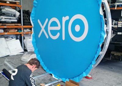 Xero sign material being stretched onto welded frame