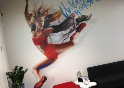 Unleash yourself - wall wrap digitally printed art of an athlete kicking in the air