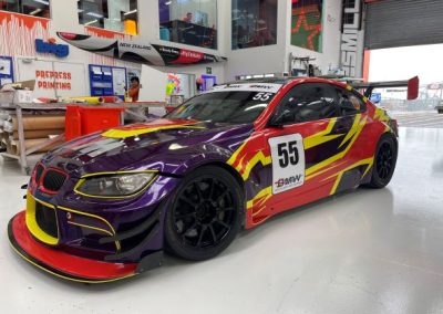 GT3 Style BMW track car with purple, yellow, and red livery