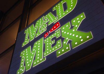 Mad Mex illuminated green and red brand signage