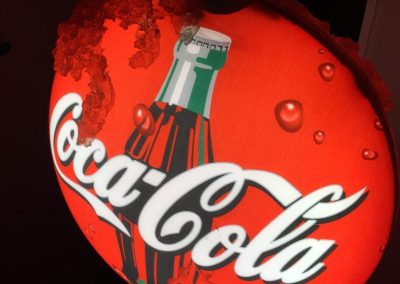 Coca Cola backlit sign with classic bottle image